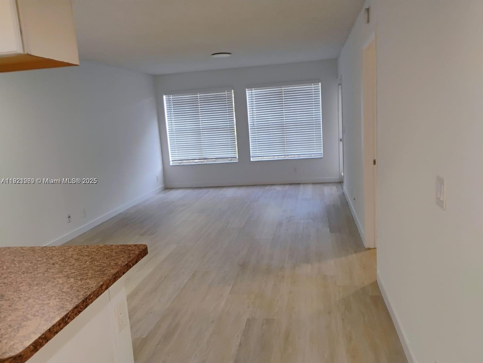 an empty room with wooden floor