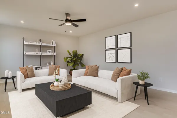 a living room with furniture a rug potted plant and a window