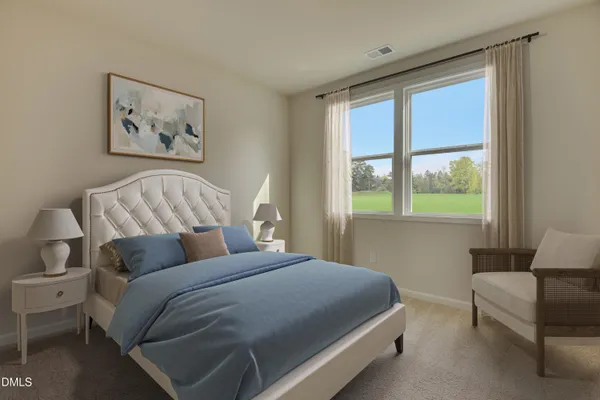 a bedroom with a bed and a couch next to a window