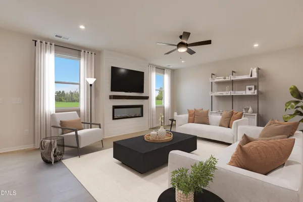 a living room with furniture flat screen tv and a large window