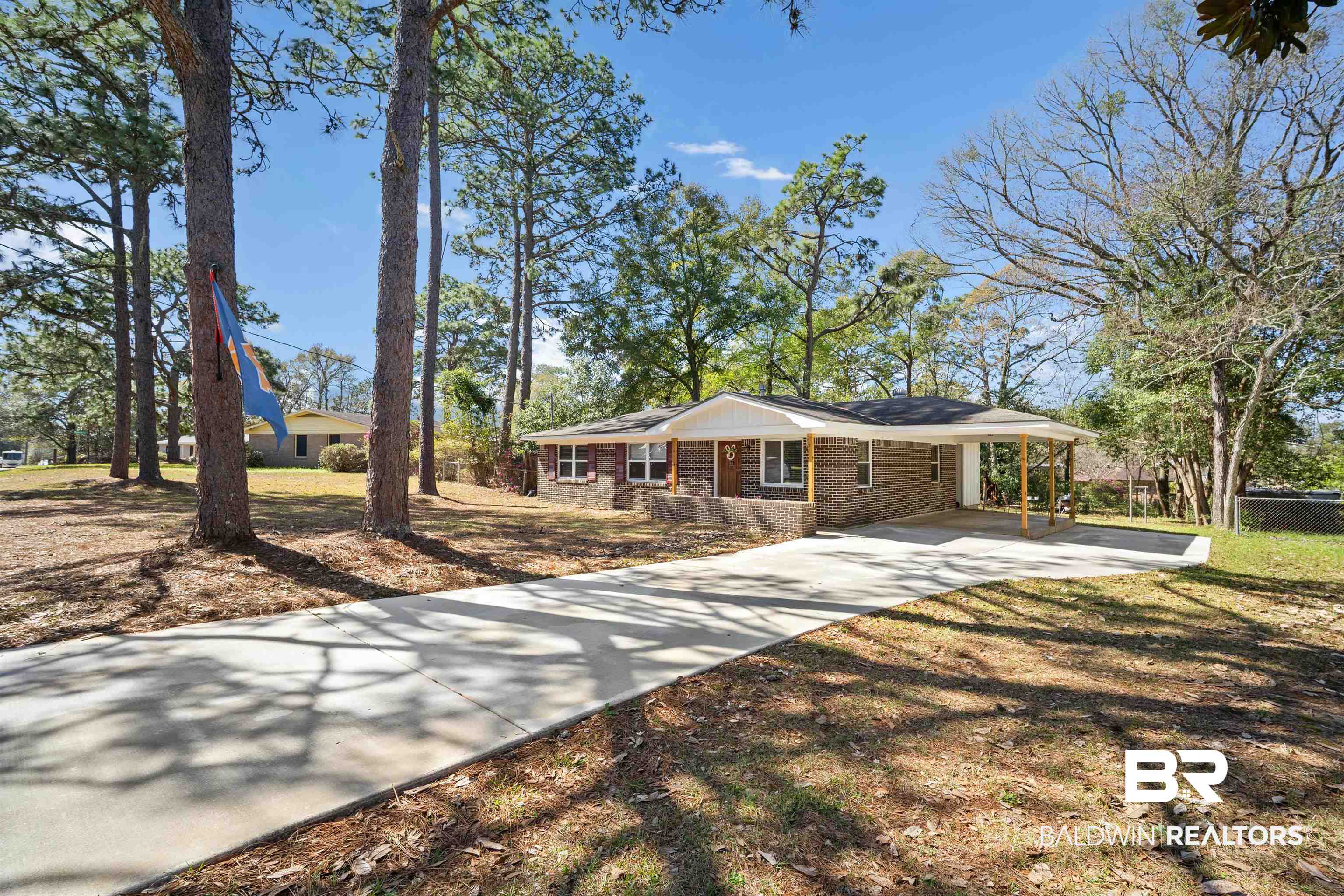672 Tarawa Drive Mobile, AL 36609 - Photo 5 of 26 Single story home with brick siding, an attached carport, driveway, and a front lawn