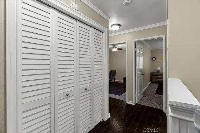 a view of a hallway with wooden floor and staircase