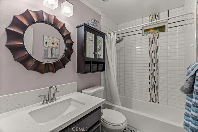 a bathroom with a toilet a sink and a mirror