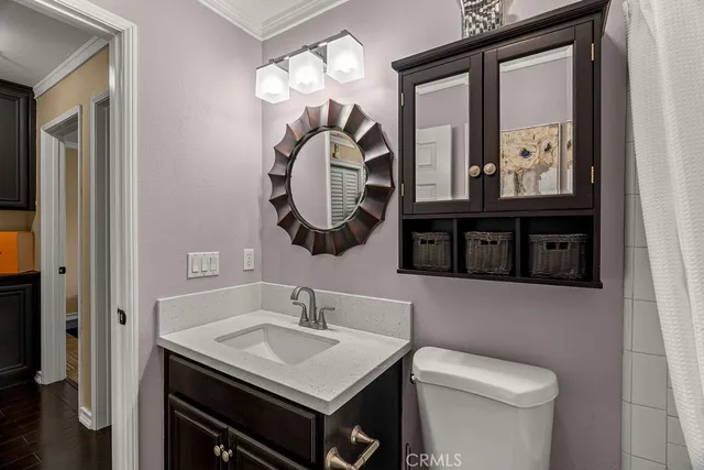 a spacious bedroom with a bed a dresser and a flat screen tv