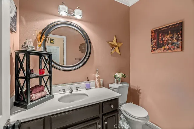 a bathroom with a toilet a sink and a mirror