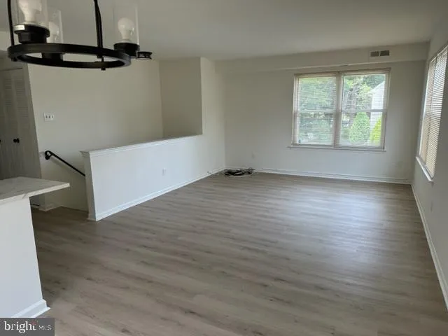 a large kitchen with cabinets wooden floor and a fireplace