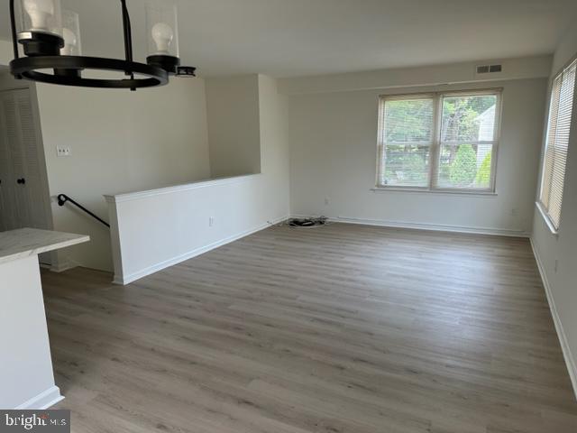 602 South Dove Road, Unit B Yardley, PA 19067 - Photo 4 of 16 wooden floor in an empty room with a window