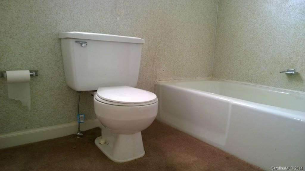 1709 Mayesville Road Morven, NC 28119 - Photo 14 of 21 a white toilet sitting next to a bathtub