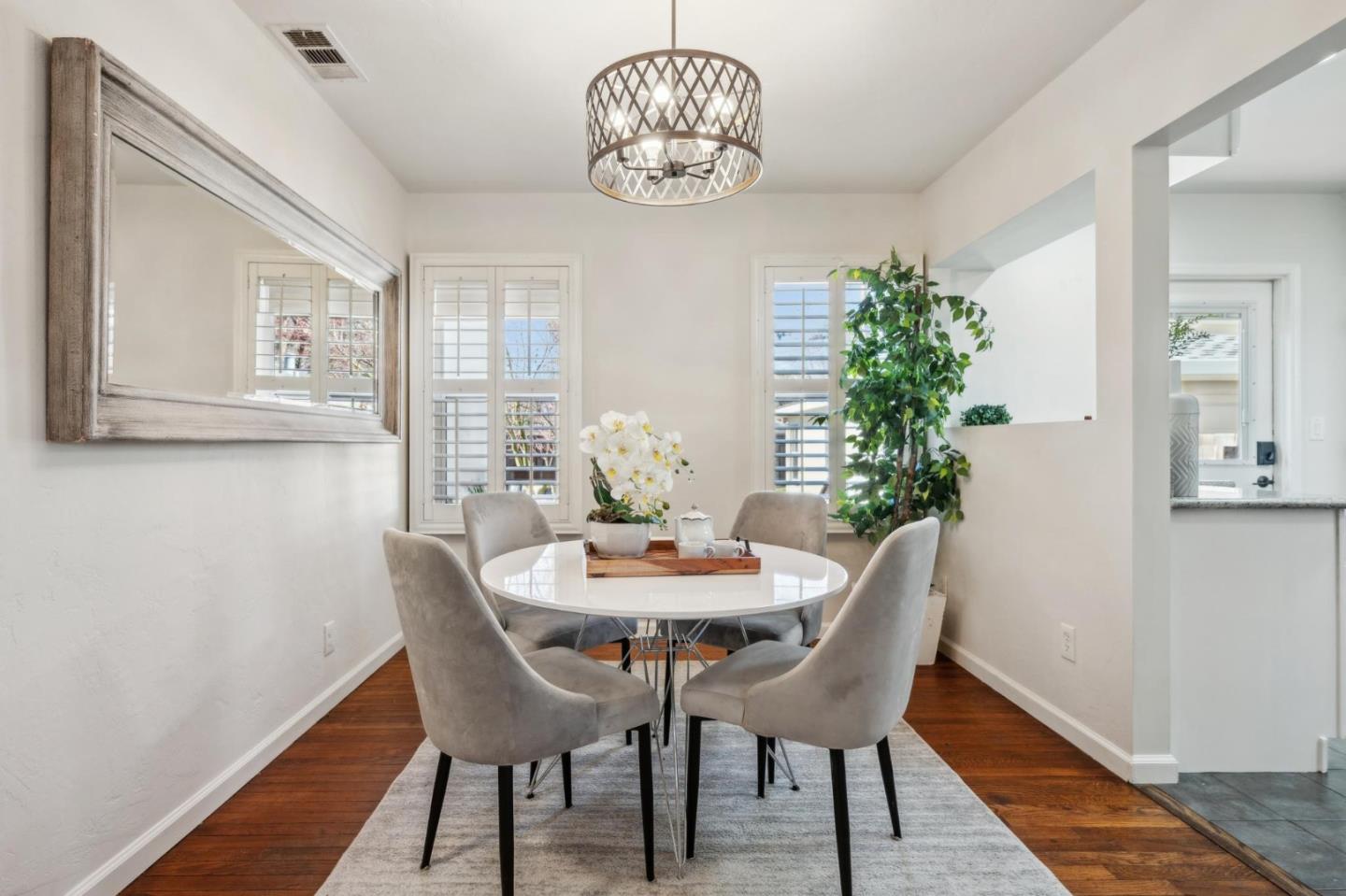 1035 Henderson Avenue Menlo Park, CA 94025 - Photo 17 of 38 a dining room with furniture a chandelier and wooden floor