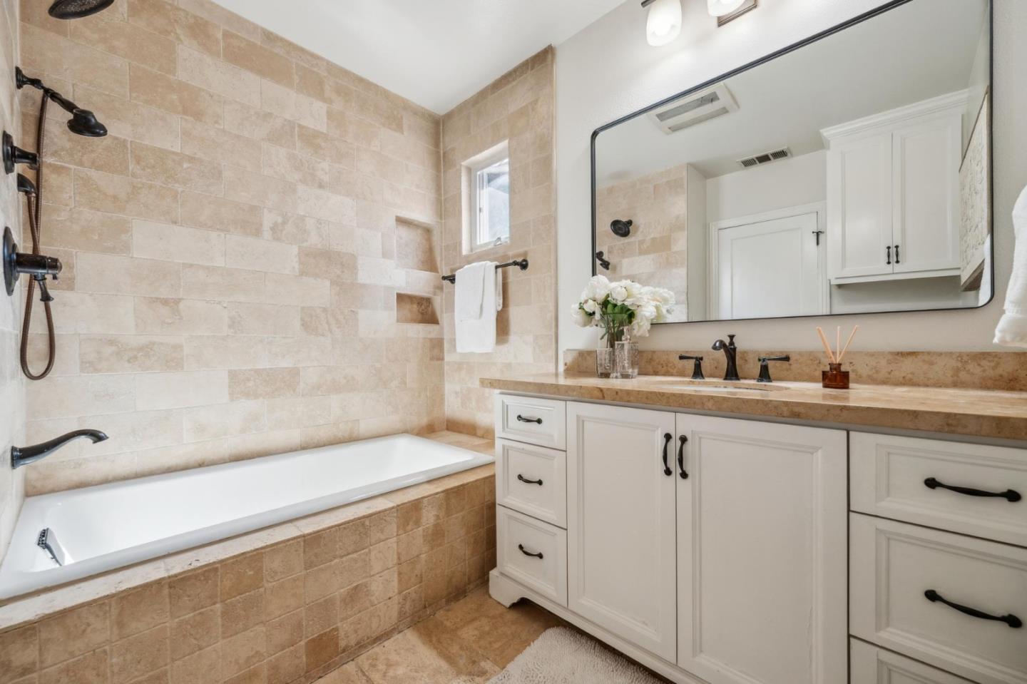 1035 Henderson Avenue Menlo Park, CA 94025 - Photo 9 of 38 a bathroom with a sink a large mirror and a bathtub
