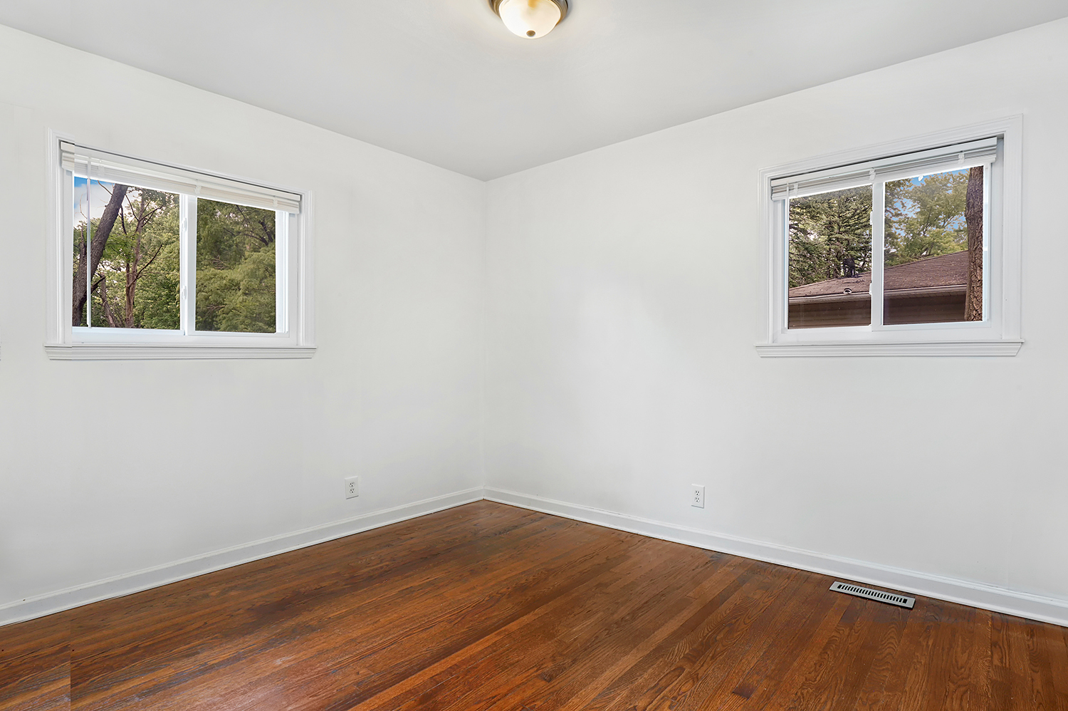 231 West 35th Street Steger, IL 60475 - Photo 14 of 17 a view of an empty room with wooden floor and a window