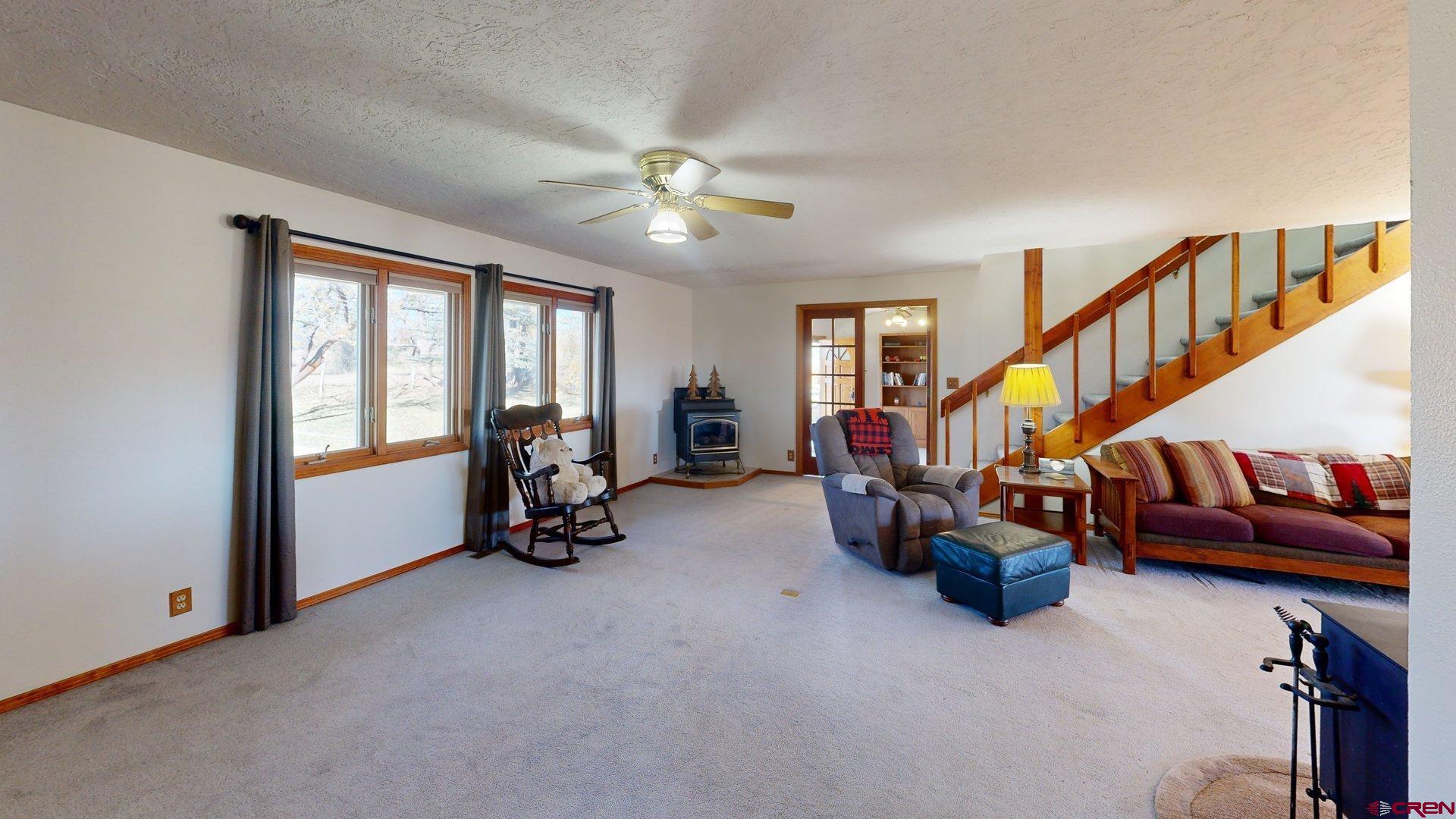 930 County Road 229 Durango, CO 81301 - Photo 11 of 32 a living room with furniture and a chandelier