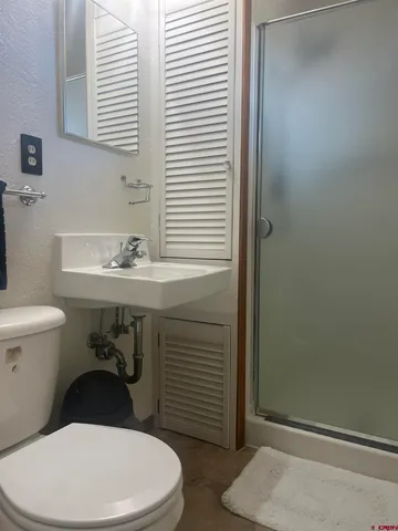 a bathroom with a sink a toilet and a window