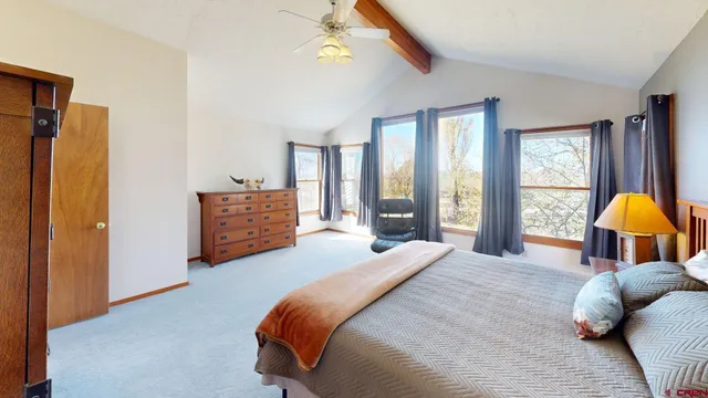 a bedroom with a bed and a lamp