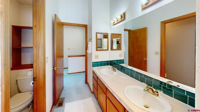 a bathroom with a granite countertop tub and a sink
