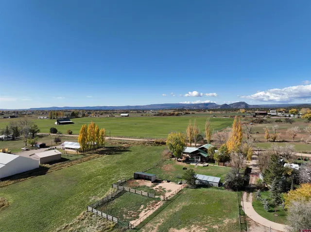 a view of a swimming pool and lounge chairs in back yard
