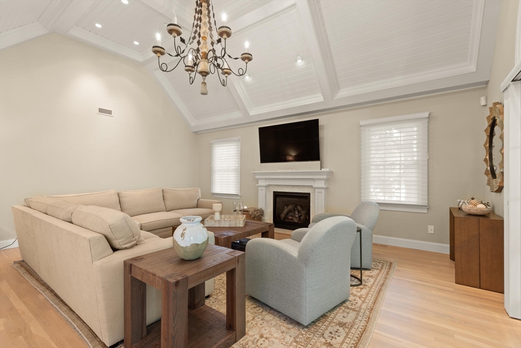 54 Greensward Circle Mashpee, MA 02649 - Photo 16 of 42 a living room with furniture a fireplace and a flat screen tv