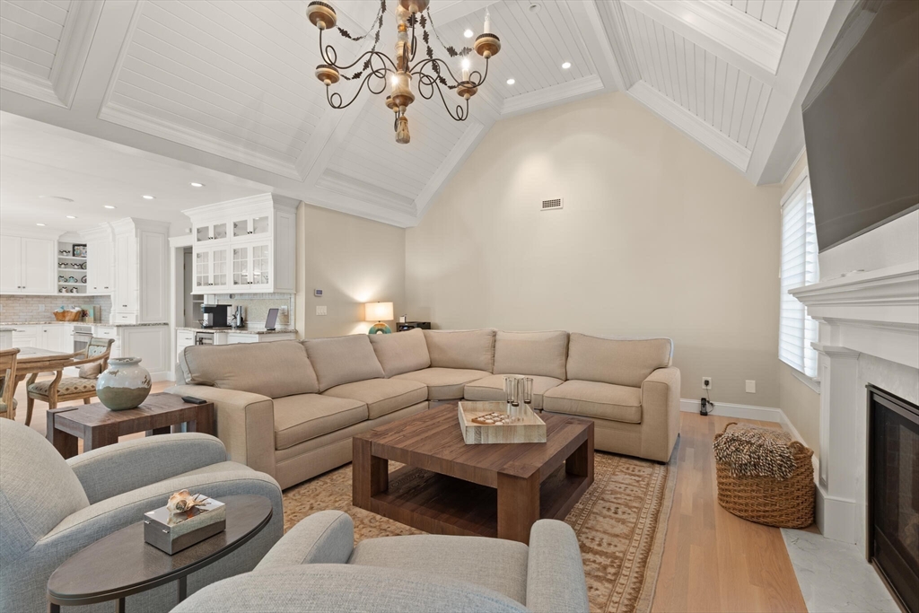 54 Greensward Circle Mashpee, MA 02649 - Photo 17 of 42 a living room with furniture a fireplace and a chandelier