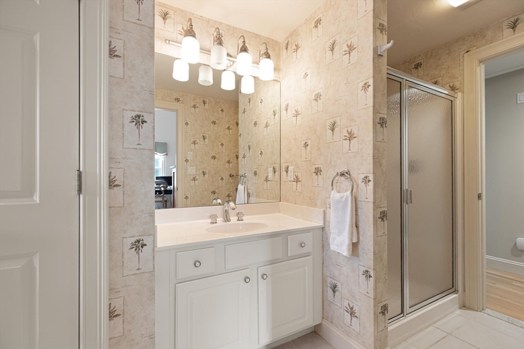 54 Greensward Circle Mashpee, MA 02649 - Photo 26 of 42 a bathroom with a double vanity sink mirror and shower