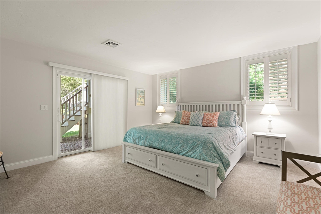 54 Greensward Circle Mashpee, MA 02649 - Photo 33 of 42 a spacious bedroom with a bed and a table