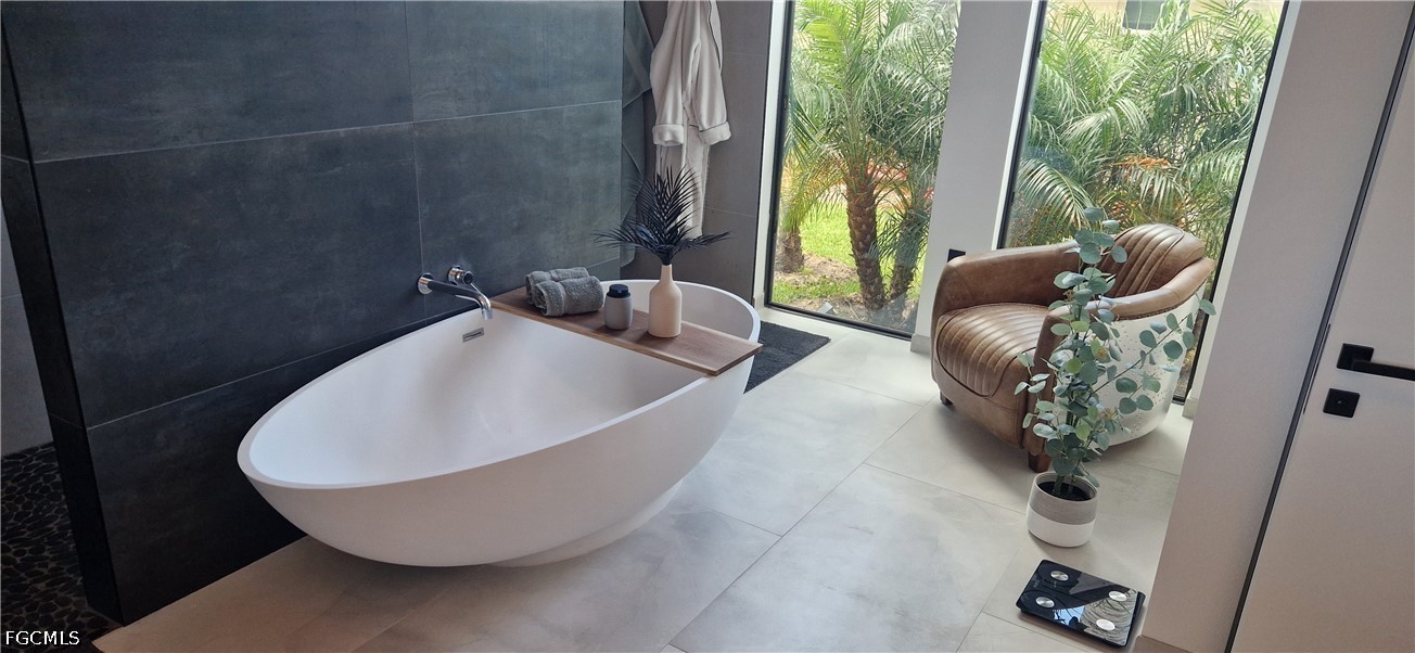 14 Burnt Store Road Cape Coral, FL 33991 - Photo 17 of 30 a white bath tub sitting in a bathroom next to a window