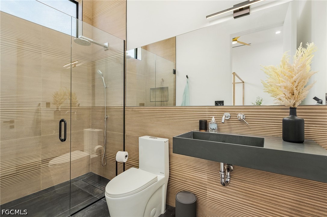 14 Burnt Store Road Cape Coral, FL 33991 - Photo 19 of 30 a bathroom with a sink a toilet and shower