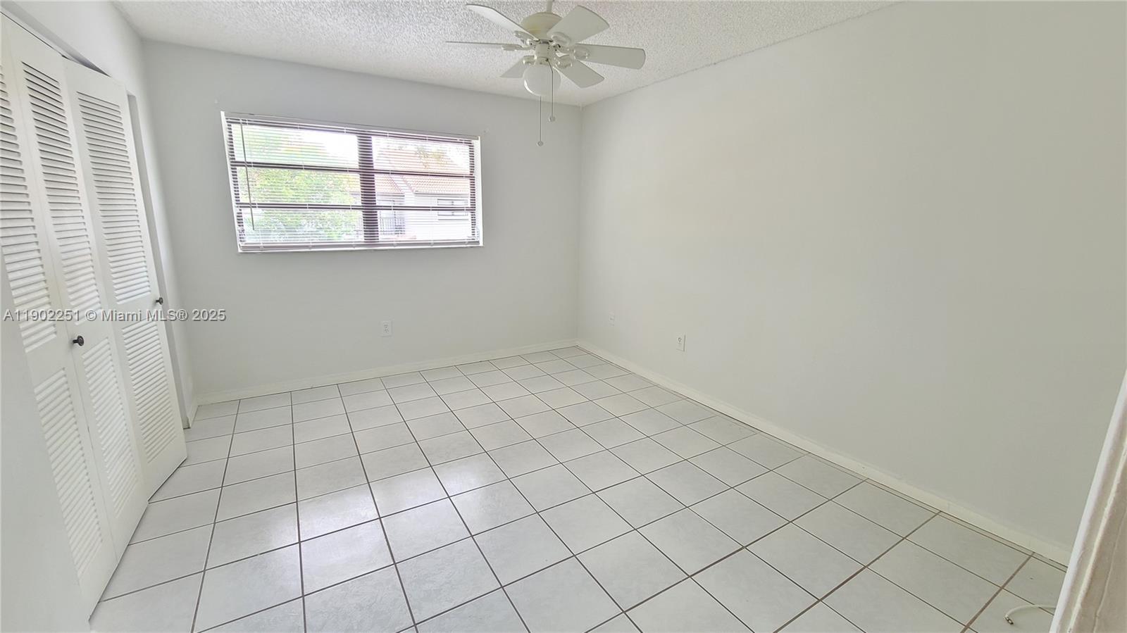 13458 Southwest 62nd Street, Unit Q105 Miami, FL 33183 - Photo 10 of 16 an empty room with windows