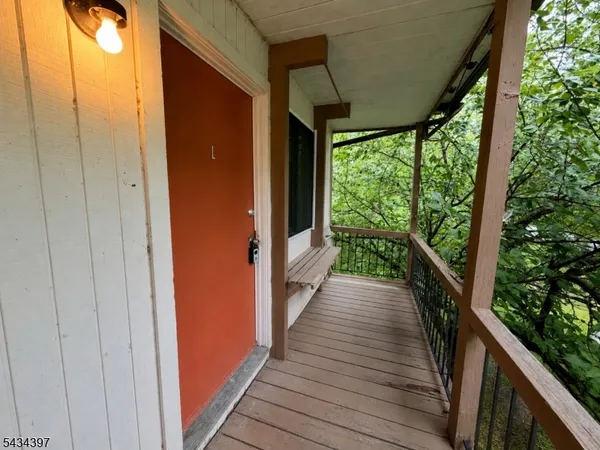 a view of balcony with wooden floor