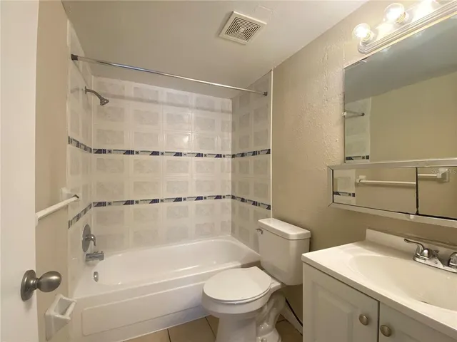 a bathroom with a sink mirror toilet and bathtub