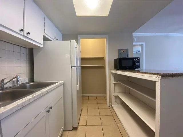 a kitchen with a sink and refrigerator