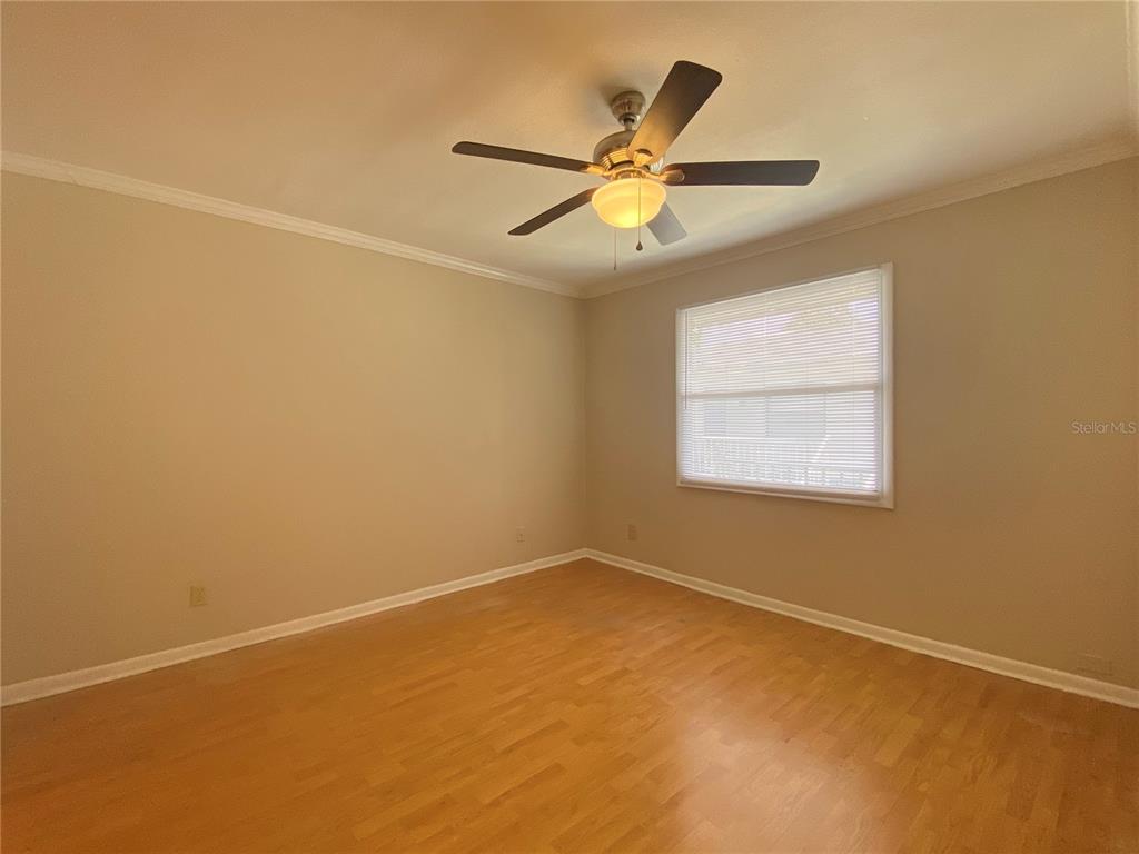 5115 Curry Ford Road, Unit 3 Orlando, FL 32812 - Photo 9 of 12 an empty room with a window and a fan