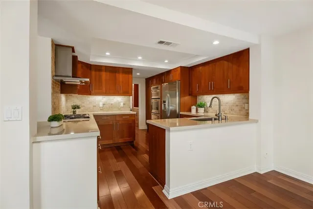 a kitchen with a sink a stove and cabinets