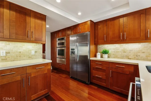 a kitchen with stainless steel appliances granite countertop a refrigerator and cabinets