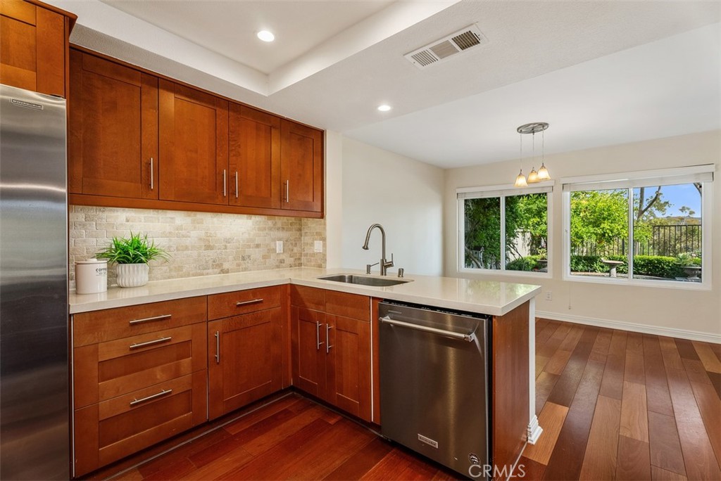 26 Southern Wood Irvine, CA 92603 - Photo 16 of 31 a kitchen with wooden cabinets and sink