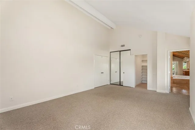 an empty room with closet area