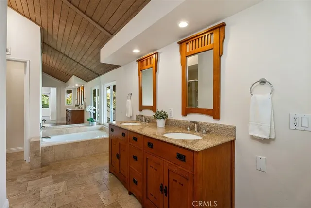 a bathroom with a granite countertop sink mirror and double