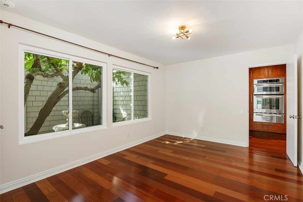 26 Southern Wood Irvine, CA 92603 - Photo 10 of 31 a view of an empty room with wooden floor and a window