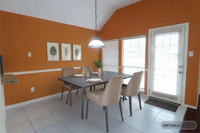a view of a dining room with furniture and window