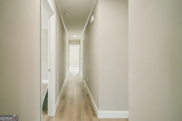 a view of a hallway with wooden floor