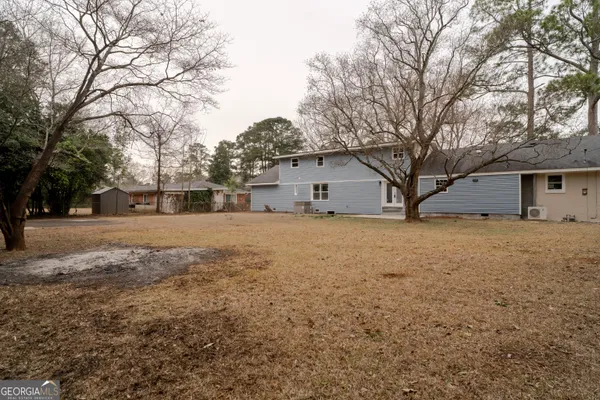 a front view of house with yard and trees