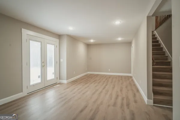 wooden floor in an empty room with a window