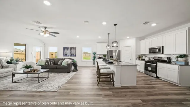a living room with furniture kitchen view and a chandelier