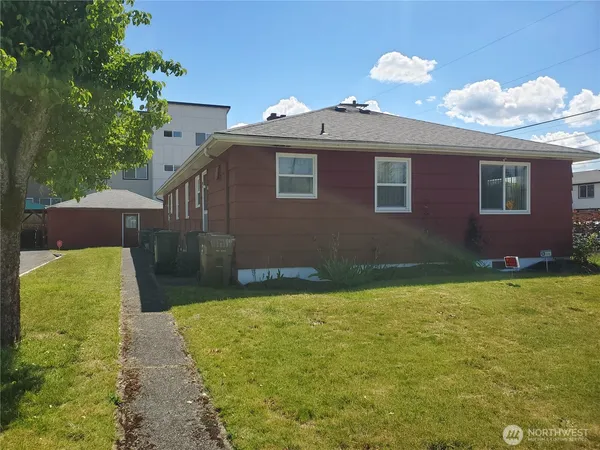 a backyard of a house with yard and outdoor seating