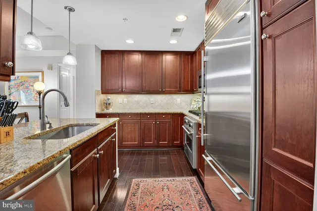 a kitchen with a refrigerator a sink and cabinets