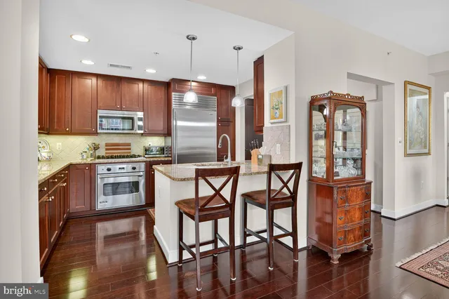 a kitchen with stainless steel appliances granite countertop a stove top oven a sink and dishwasher