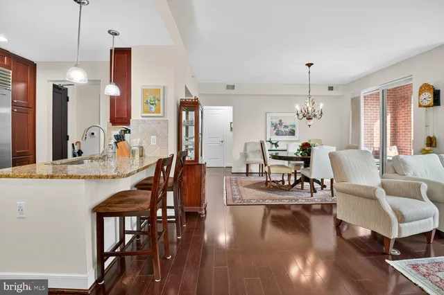 a view of a dining room with furniture wooden floor and chandelier