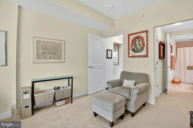 a living room with furniture and a painting on the wall