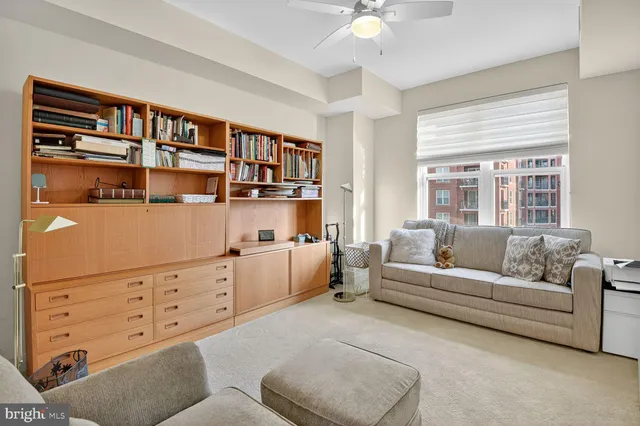 a living room with furniture cabinets and a window