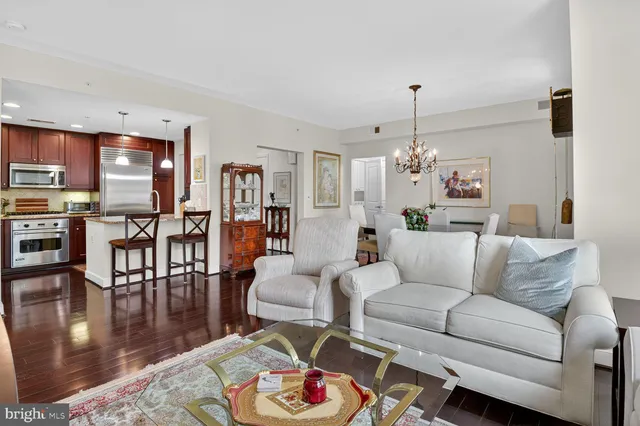 a living room with furniture and a chandelier