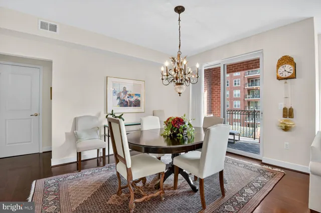 a dining room with furniture a rug and wooden floor